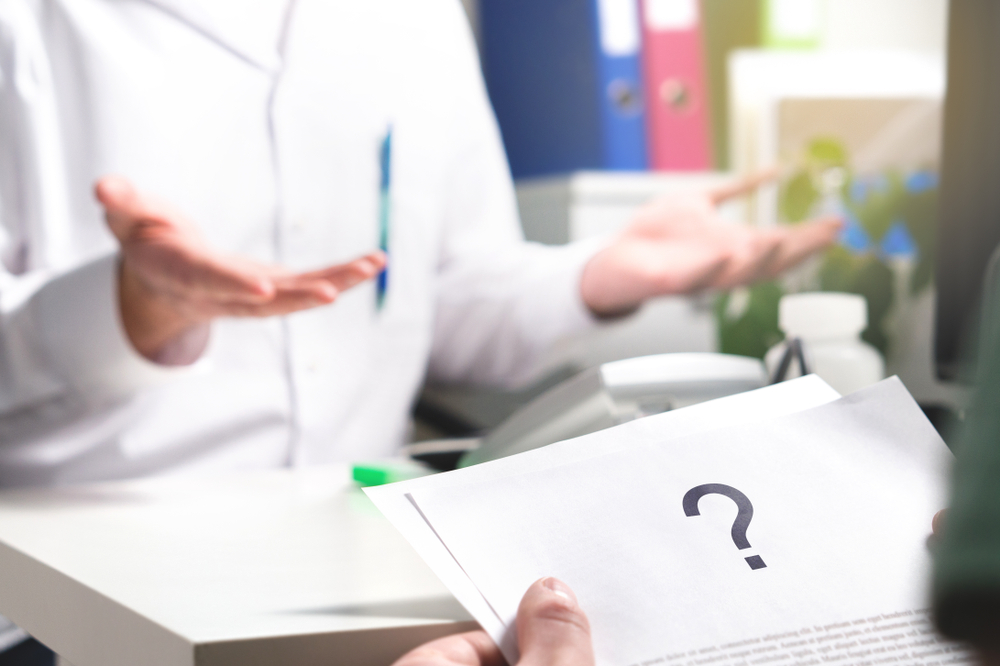 patient reading health care document with question mark