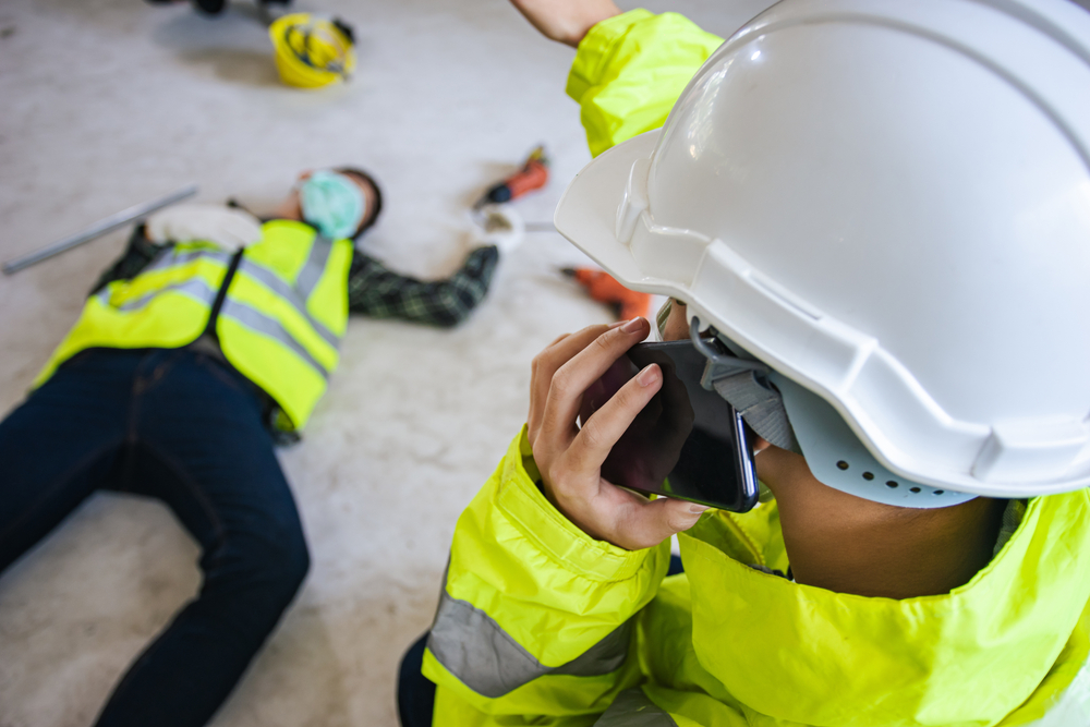 supervisor helping call to safety team for support employee accident in site work