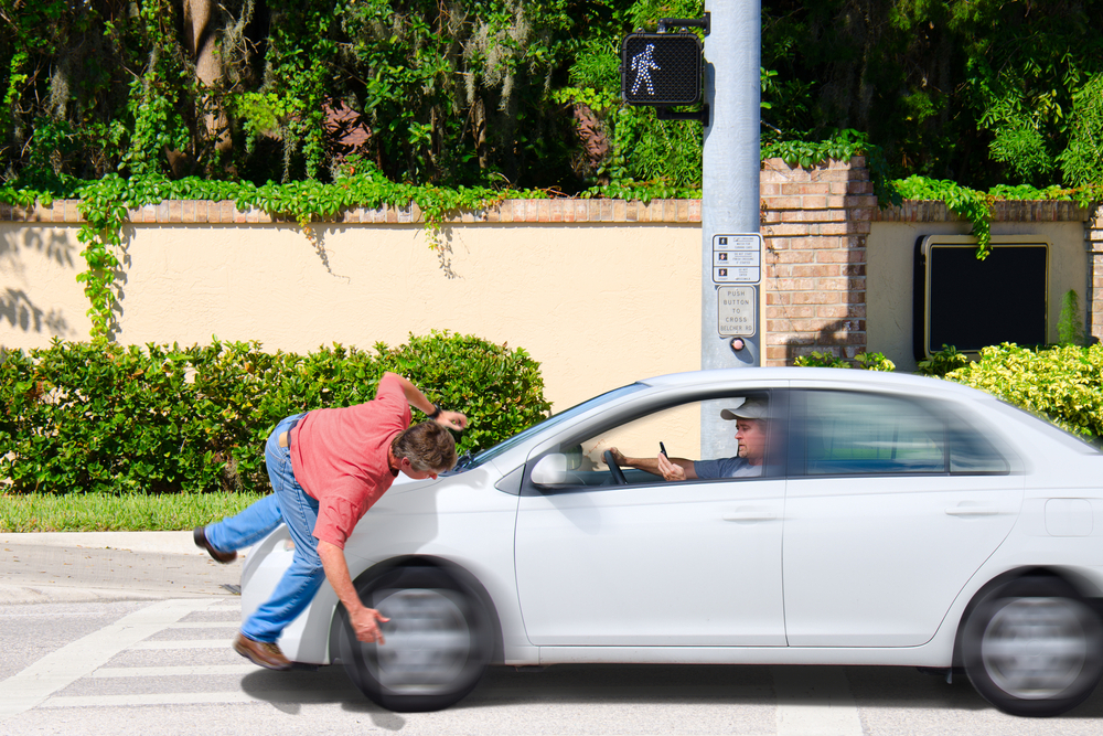 a man that is texting while driving runs over a pedestrian while the cross now sign is clearly visible showing that the pedestrian had the right of way